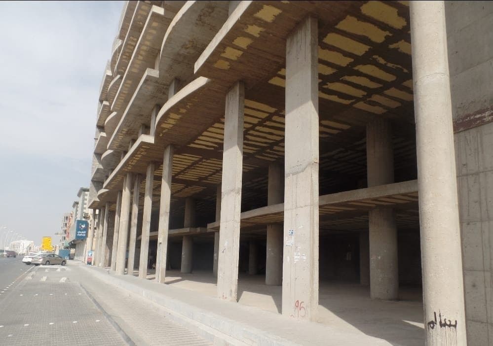 Multi-storey concrete frame to a commercial building, with ribbed slabs and block infill.